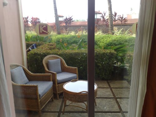 Relaxing outdoor seating with garden view.